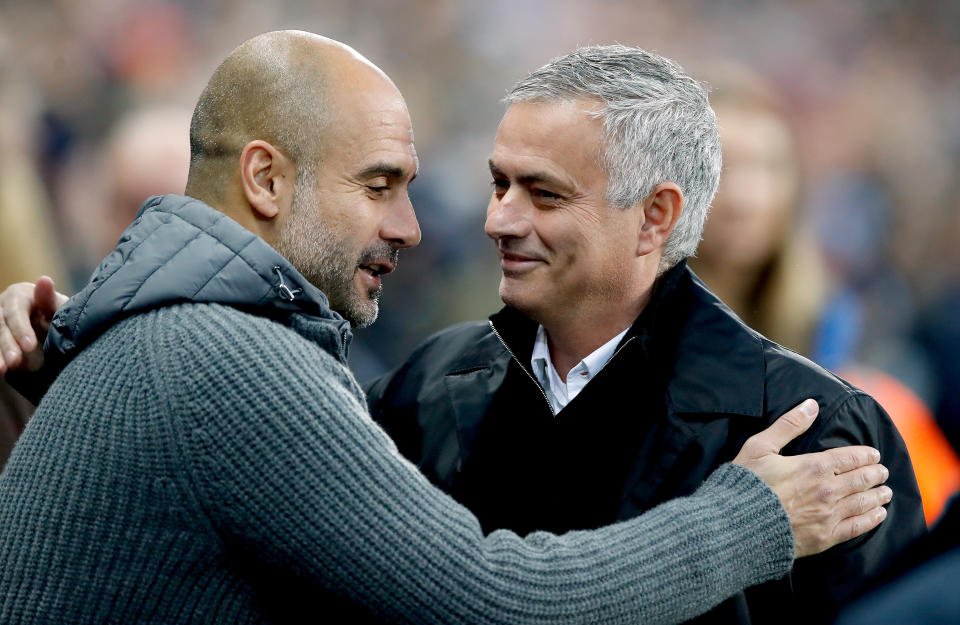 Pep Guardiola (left) and Jose Mourinho embrace before the Manchester derby at the Etihad