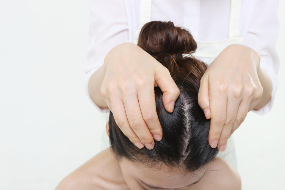 Get a family member or hairdresser to tell you if they notice any spots or moles on your scalp. (Photo via Getty Images)