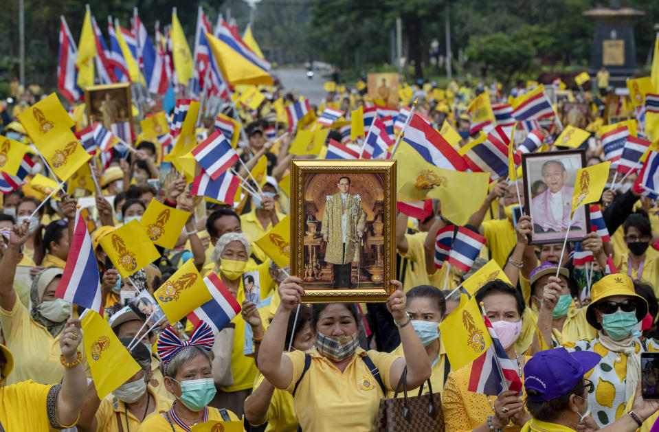 Supporters of the Thai monarchy display images of the late King Bhumibol Adulyadej during a rally at Lumphini park in central Bangkok, Thailand, Tuesday, Oct. 27, 2020. Hundreds of royalists gathered to oppose pro-democracy protesters' demands that the prime minister resign, constitution be revised and the monarchy be reformed in accordance with democratic principles. (AP Photo/Gemunu Amarasinghe)