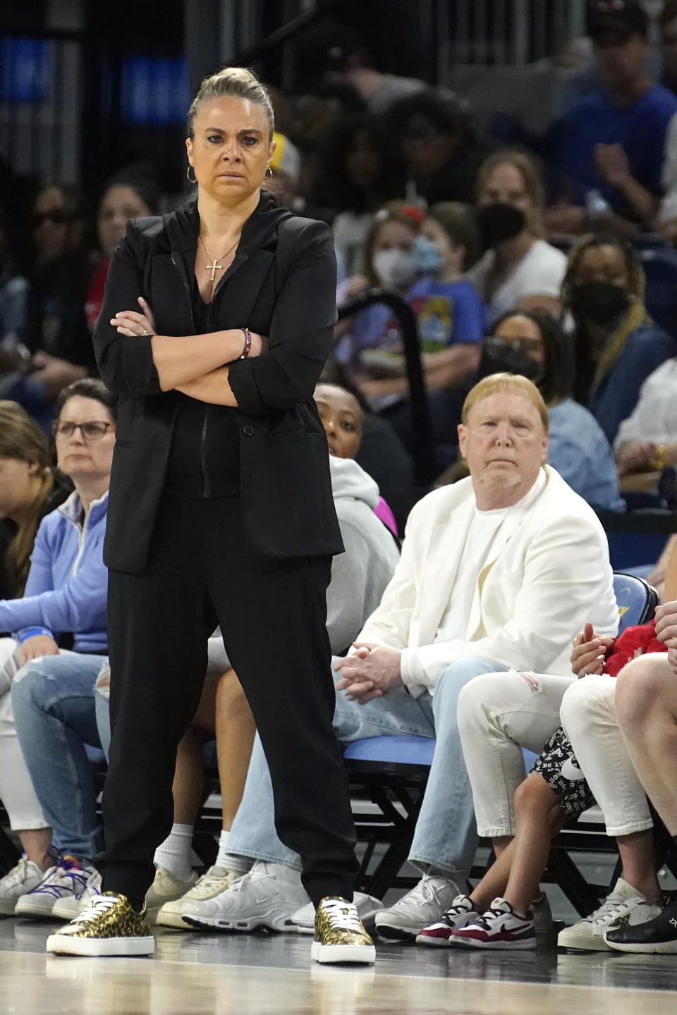 Las Vegas Aces head coach Becky Hammon, left, and team owner Mark Davis watch during the first half of the WNBA Commissioner's Cup basketball game between the Chicago Sky and the AcesTuesday, July 26, 2022, in Chicago. (AP Photo/Charles Rex Arbogast)