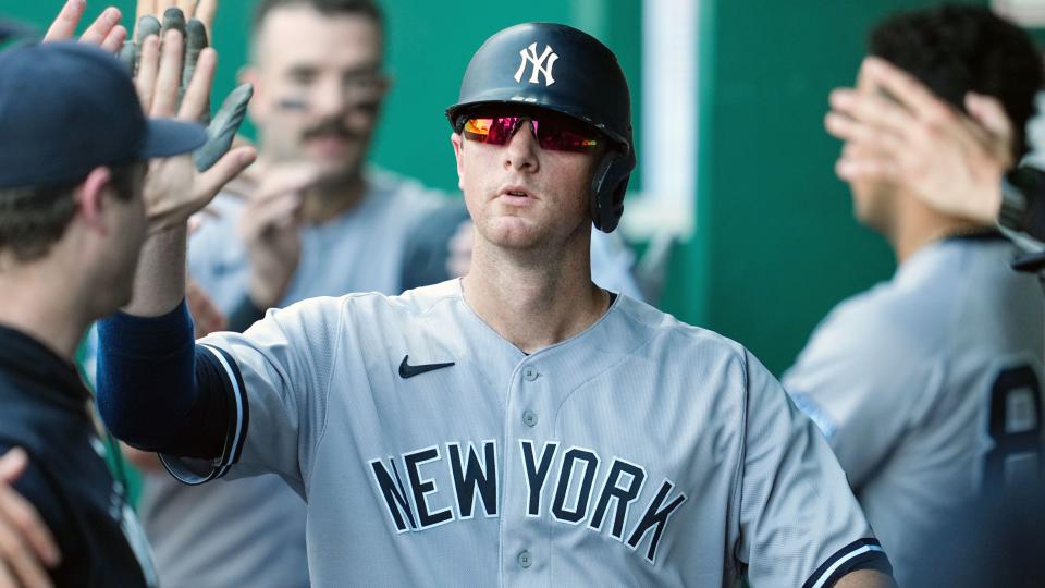 New York Yankees first baseman DJ LeMahieu (26) is congratulated by teammate after scoring during the sixth inning against the Kansas City Royals at Kauffman Stadium