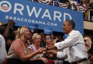 President Barack Obama shakes hands at a campaign event at the B.R. Miller Middle School in Marshalltown, Iowa, August 14, 2012.