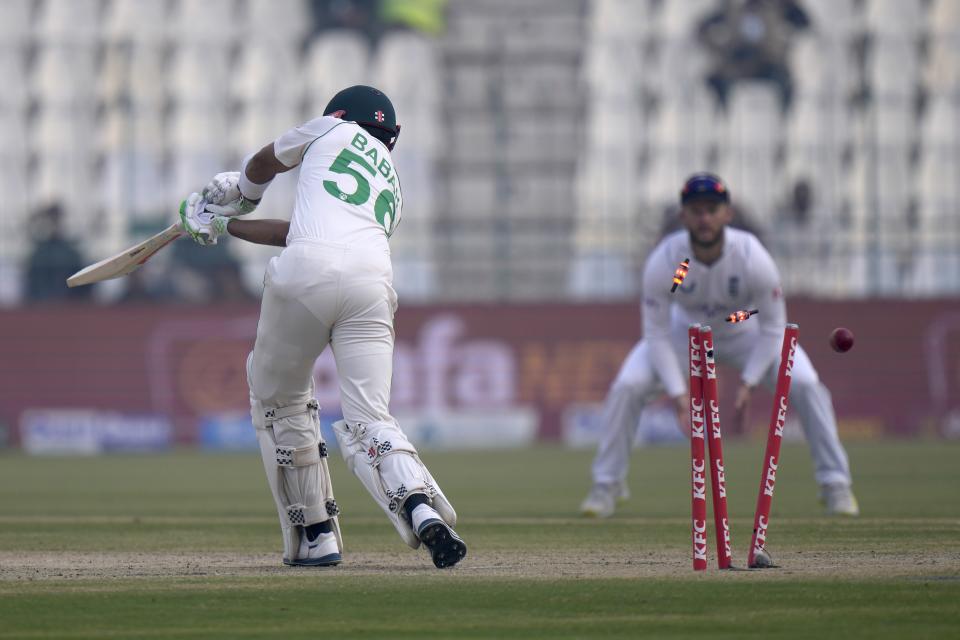 Pakistan Babar Azam is bowled out by England's Ollie Robinson during the second day of the second test cricket match between Pakistan and England, in Multan, Pakistan, Saturday, Dec. 10, 2022. (AP Photo/Anjum Naveed)