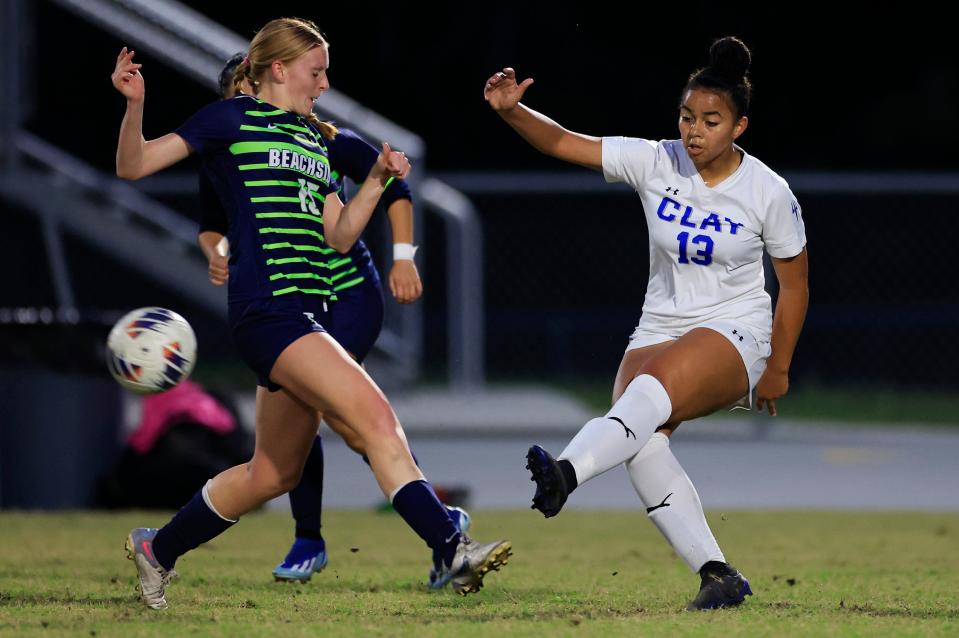 Clay's Brooke Bunton (13) kicks the ball past the Beachside defense in a February playoff.