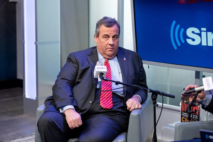 Chris Christie leaning in a chair for a radio interview