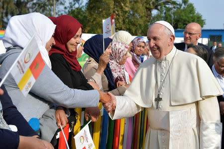 Pope Francis greets women during a visit to a rural social service run by the Daughters of Charity of St. Vincent de Paul in Temara, near Rabat, Morocco March 31, 2019. Vatican Media/­Handout via REUTERS