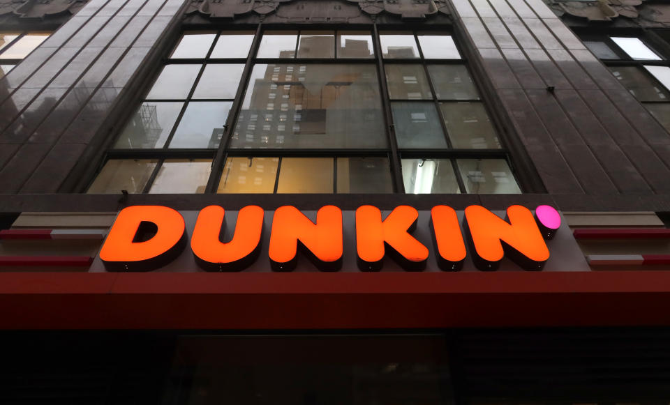 NEW YORK, NY - DECEMBER 16: The corporate logo for Dunkin', replacing the former name of Dunkin Donuts sits above the entrance to a store on 38th Street on December 16, 2019, in New York City. (Photo by Gary Hershorn/Getty Images)