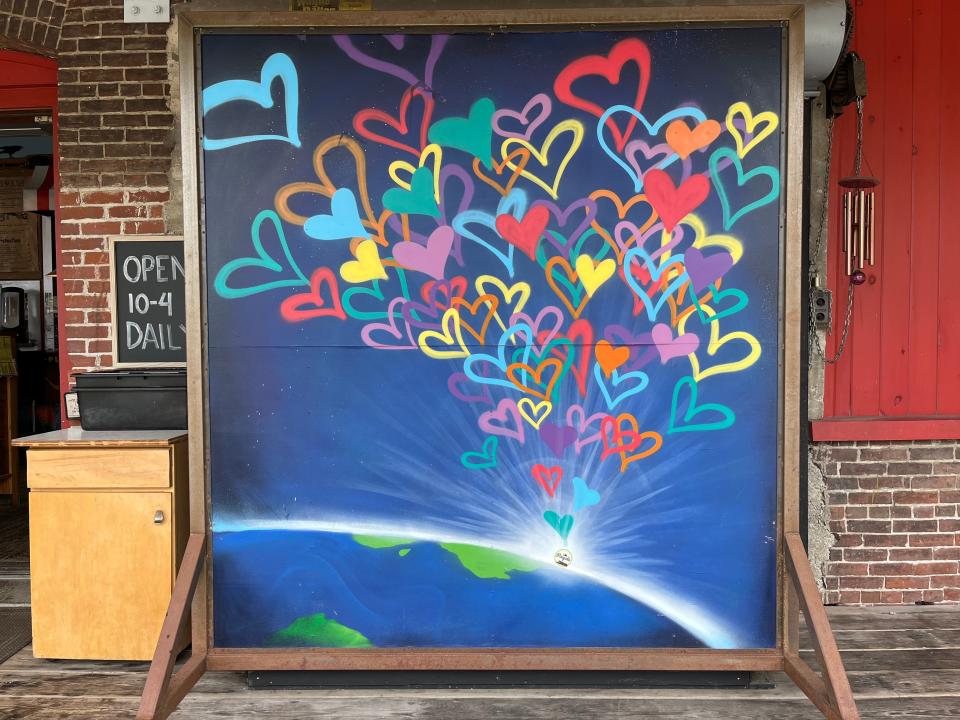 This mural outside Pingala at Chace Mill shows hearts coming out of Pingala's little spot on Earth. Because the mural is on a double-sided chalkboard, people may see a different mural depending on the day.