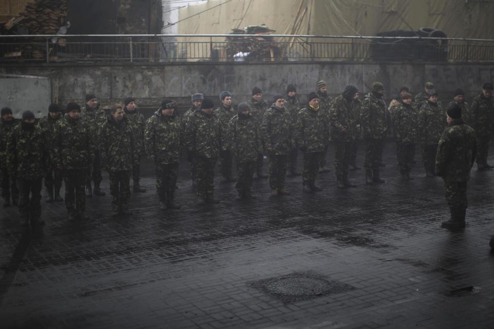 Ukrainian recruits line up as they receive military instructions from a commander at a recruitment center in Kiev's Independence Square, Ukraine, Tuesday, March 4, 2014. Vladimir Putin ordered tens of thousands of Russian troops participating in military exercises near Ukraine's border to return to their bases as U.S. Secretary of State John Kerry was on his way to Kiev. Tensions remained high in the strategic Ukrainian peninsula of Crimea with troops loyal to Moscow fired warning shots to ward off protesting Ukrainian soldiers. (AP Photo/Emilio Morenatti)
