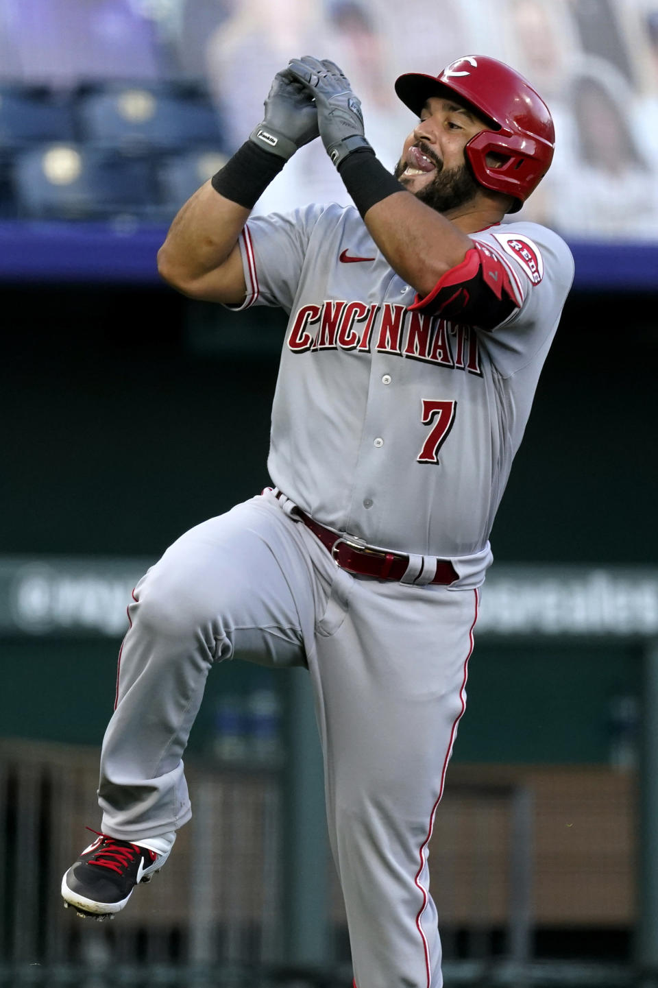 Cincinnati Reds' Eugenio Suarez celebrates after hitting a solo home run during the third inning of Game 2 of a baseball doubleheader against the Kansas City Royals on Wednesday, Aug. 19, 2020, in Kansas City, Mo. (AP Photo/Charlie Riedel)