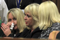 June Steenkamp, the mother of Reeva Steenkamp, left, and unidentified women sit inside the high court prior to the start of a murder trial in Pretoria, South Africa, Monday, March 3, 2014. Oscar Pistorius is charged with murder with premeditation in the shooting death of girlfriend Reeva Steenkamp in the pre-dawn hours of Valentine's Day 2013. (AP Photo/Themba Hadebe, Pool)