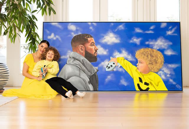 Sophie Brussaux Instagram Sophie Brussaux and Adonis in front of a portrait she drew of her son and Drake for Father's Day in 2022