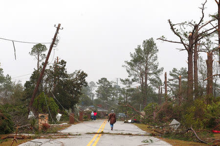 Residents survey damage after a tornado struck a residential area on Sunday in Albany, Georgia. REUTERS/Tami Chappell