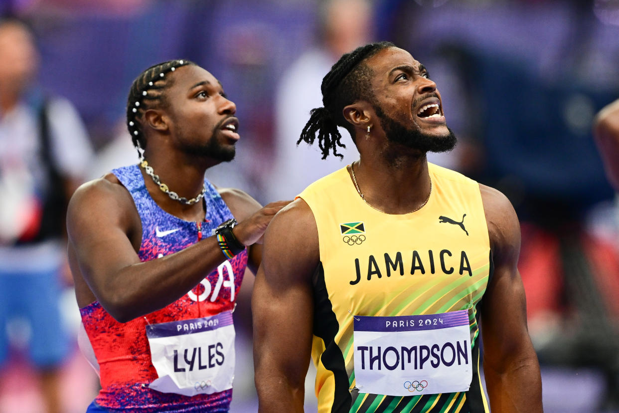 SAINT-DENIS, FRANCE - AUGUST 04: Noah Lyles (L) of US and Kishane Thompson (R) of Jamaika wait for the results of the competition during the men's 100m final of the athletics event at the Paris 2024 Olympic Games at Stade de France in Saint-Denis, north of Paris, on August 4, 2024. (Photo by Mehmet Murat Onel/Anadolu via Getty Images)