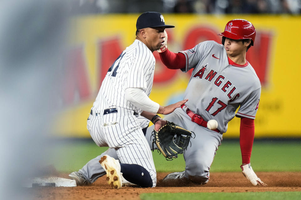 Los Angeles Angels' Shohei Ohtani slides past New York Yankees' Oswald Peraza, left, as he steals second base during the fifth inning of a baseball game Tuesday, April 18, 2023, in New York. Ohtani advanced to third base on an error. (AP Photo/Frank Franklin II)