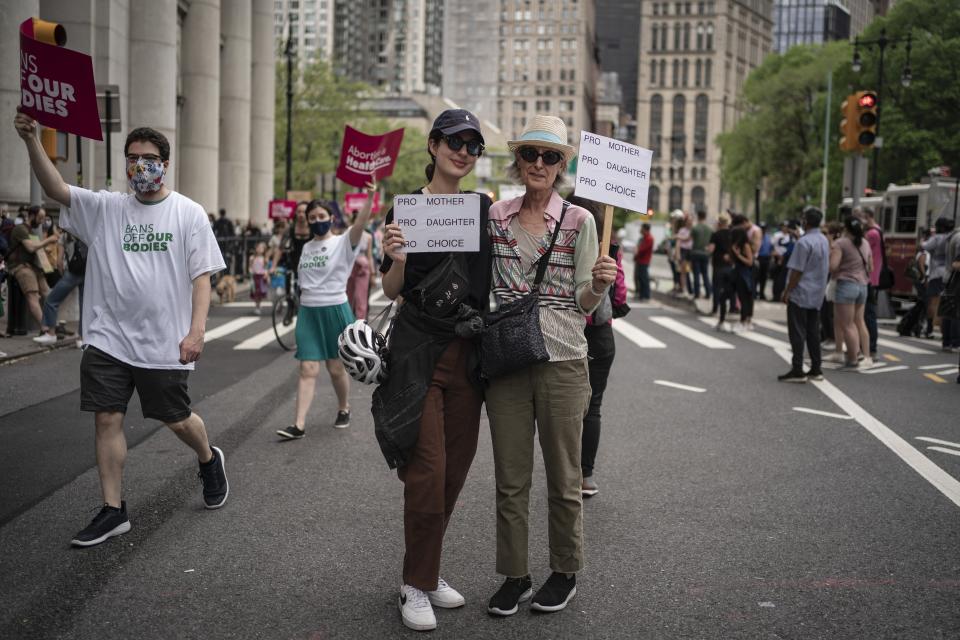 Lindsay Walt, 66, and her daughter, Eve Thompson, 27, stand for a portrait after marching across the Brooklyn Bridge into Manhattan on Saturday, May 14, 2022, in New York. Generations of women came together and expressed their outrage that the Supreme Court will soon scrap the constitutional right to abortion that has endured for nearly a half-century and their fear about what that could mean for women's reproductive choices. Walt protested in favor of abortion before 1973, when Roe came down. (AP Photo/Wong Maye-E)