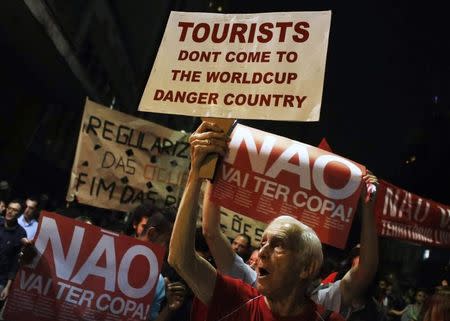 Demonstrators shout slogans during a protest against the 2014 World Cup, in Sao Paulo