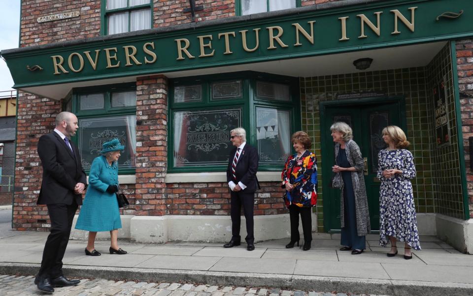 Queen Elizabeth II meets actors William Roache, fourth right, Barbara Knox, third right, Sue Nicholls and Helen Worth, right, during a visit to the set of the long running television series Coronation Street - Scott Heppell/AP