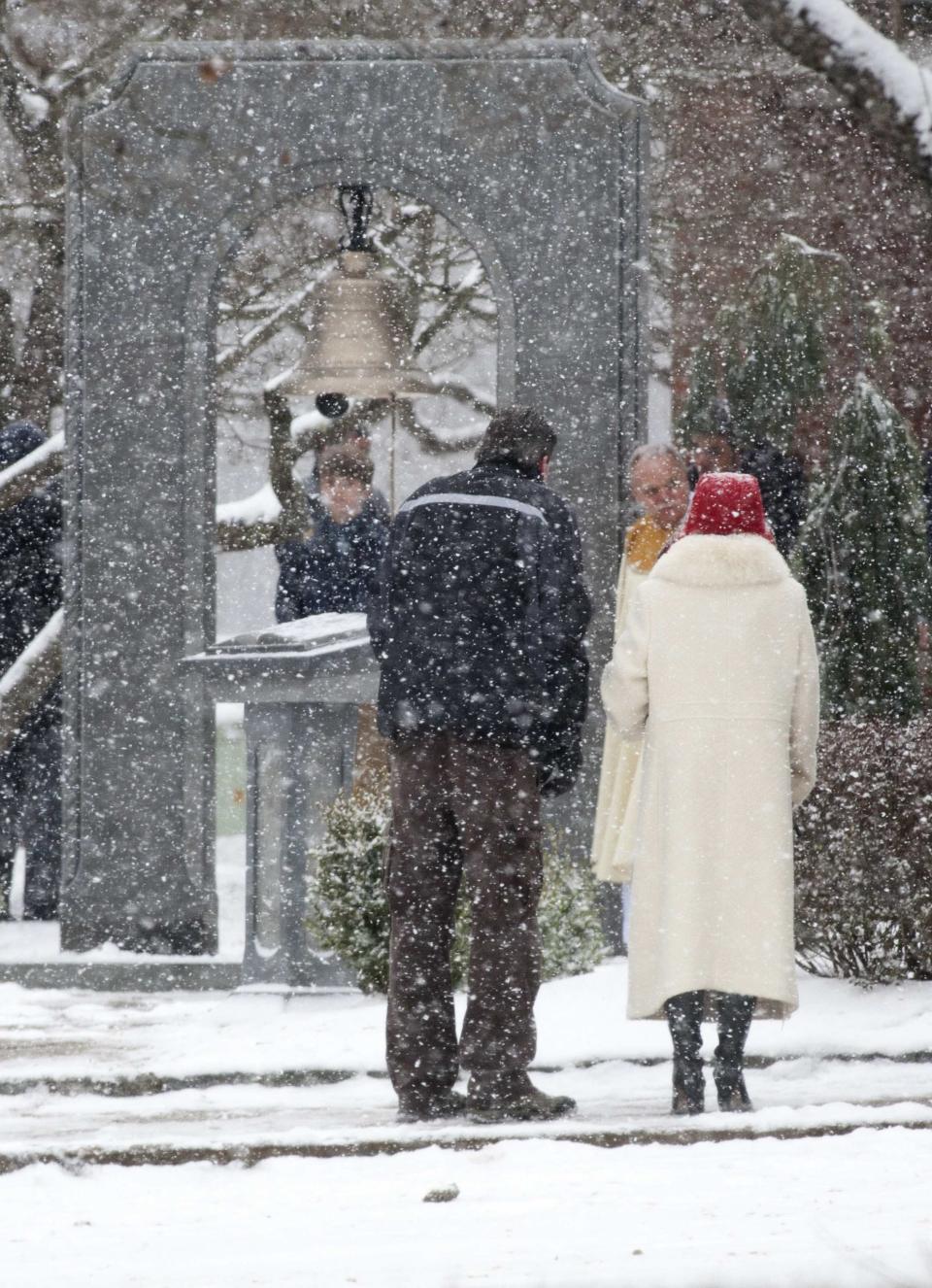 People gather following mass at St. Rose as a permanent memorial is dedicated to the victims of the Sandy Hook Elementary School shooting in Newtown