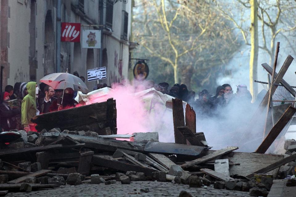 Demonstrators clash with French riot police during a demonstration in Nantes, Saturday Feb. 22, 2014, as part of a protest against a project to build an international airport, in Notre Dame des Landes, near Nantes. The project was decided in 2010 and the international airport should open by 2017. (AP Photo/ Laetitia Notarianni)
