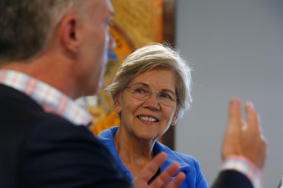 New Bedford Mayor Jon Mitchell and Massachusetts Senator Elizabeth Warren speak during a visit to the New Bedford Port Authority.