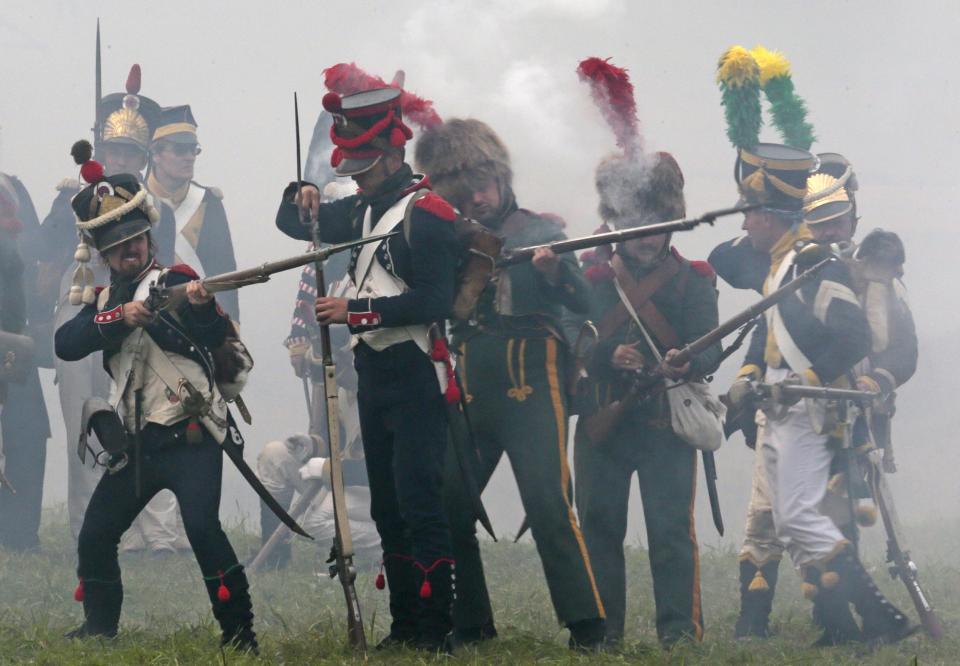 Members of historic clubs wearing 1812-era uniforms take part in a staged battle re-enactment to mark the 200th anniversary of the battle of Borodino, in Borodino, about 110 km (70 miles) west of Moscow, Sunday, Sept. 2, 2012. The Battle of Borodino in 1812 was the largest and bloodiest single-day action of the French invasion of Russia. (AP Photo/Mikhail Metzel)