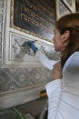 Rita Ranzato, an art restorer, uses a scalpel to take away layers of old paint from a stuccoed wall inside the 1575 Italian Schola Synagogue in Venice, northern Italy, Wednesday, June 1, 2022. Venice’s Jewish ghetto is considered the first in Europe and one of the first in the world, and a new effort is underway to preserve its 16th century synagogues for the Jews who have remained and tourists who pass through. (AP Photo/Chris Warde-Jones)