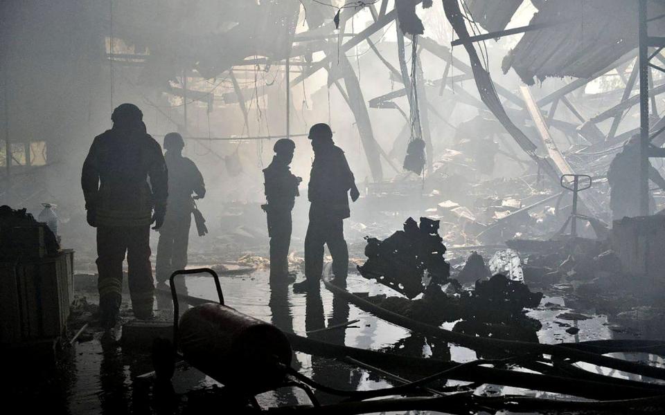 This handout photograph posted on the Telegram account of Deputy Head of the Office of the President of Ukraine Oleksiy Kuleba on May 23, 2024, shows law enforcement officers working at the site of a missile attack in Kharkiv, amid the Russian invasion of Ukraine.