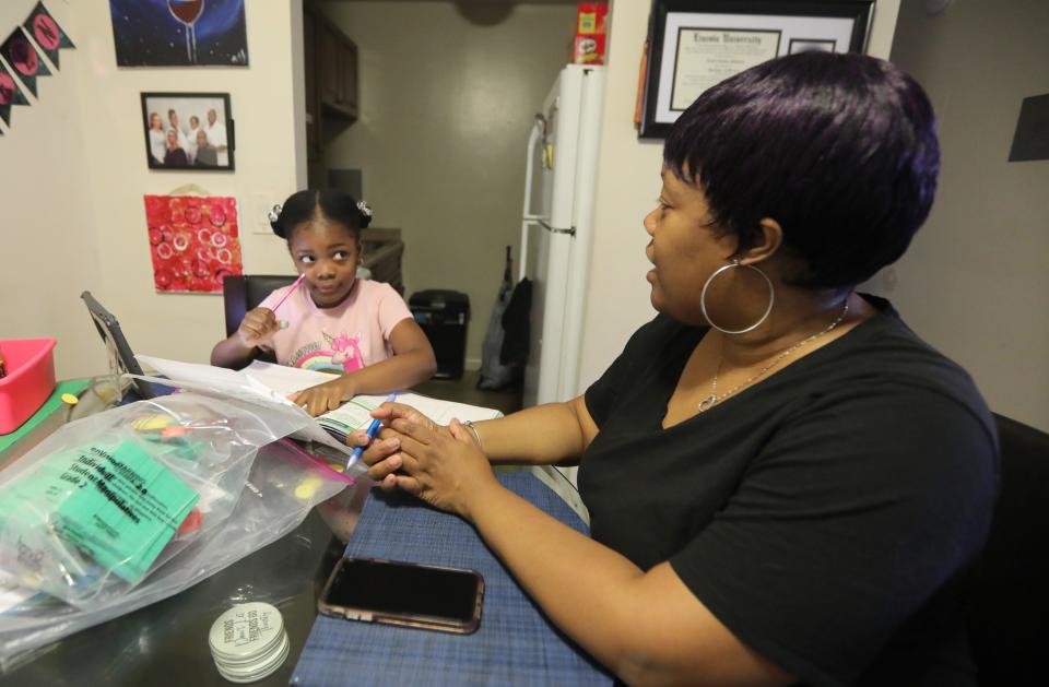 Nicole Johnson helps her daughter Khloe, 6, do school work in their White Plains home Oct. 14, 2020. Johnson, who had worked for the past eight years as a teacher's aide, was forced to give up her job in order to care for her daughter, a second-grader in the White Plains school district who is doing all virtual learning due to the COVID-19 pandemic.