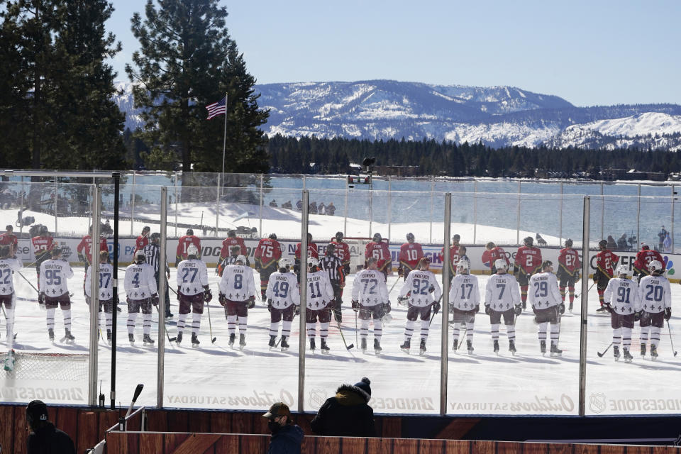 <p>Members of the Colorado Avalanche, foreground and the Vegas Golden Knights, background lineup for the national anthem at the Outdoor Lake Tahoe NHL hockey game in Stateline, Nev., Saturday, Feb. 20, 2021. (AP Photo/Rich Pedroncelli))</p> 