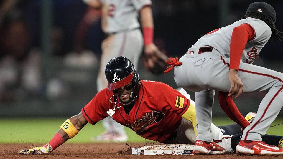 Atlanta Braves' Ronald Acuna Jr. (13) steals second base during second inning of an baseball game against Washington Nationals shortstop CJ Abrams (5), Friday, Sept. 29, 2023, in Atlanta. (AP Photo/Mike Stewart)