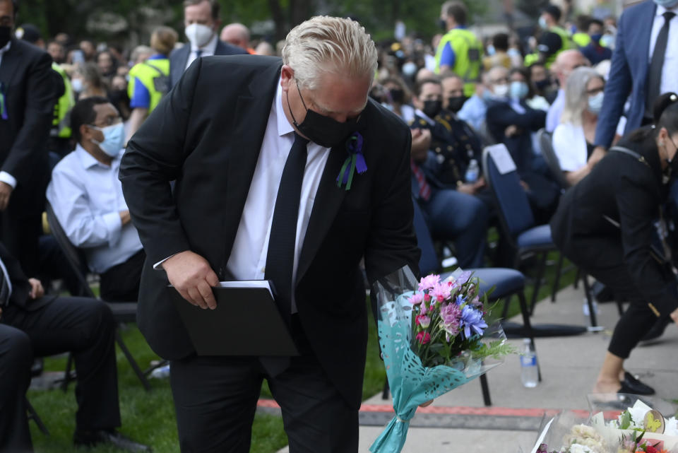 <p>Ontario Premier Doug Ford places flowers at a vigil for the victims of the deadly vehicle attack on five members of the Canadian Muslim community in London, Ont., on Tuesday, June 8, 2021. Four of the members of the family died and one is in critical condition. Police have charged a London man with four counts of murder and one count of attempted murder. THE CANADIAN PRESS/Nathan Denette</p> 