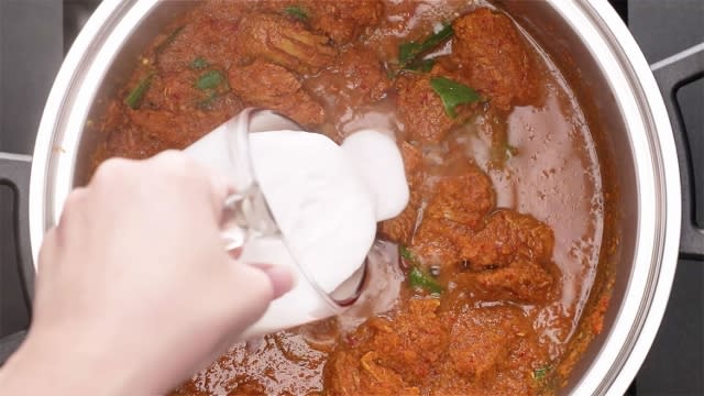 add coconut milk into the spice paste saucepan or pot 