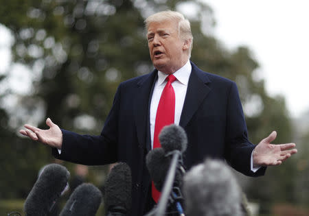 U.S. President Donald Trump takes questions from to reporters before departing the White House to speak at CPAC in Washington, U.S., February 23, 2018. REUTERS/Jim Bourg