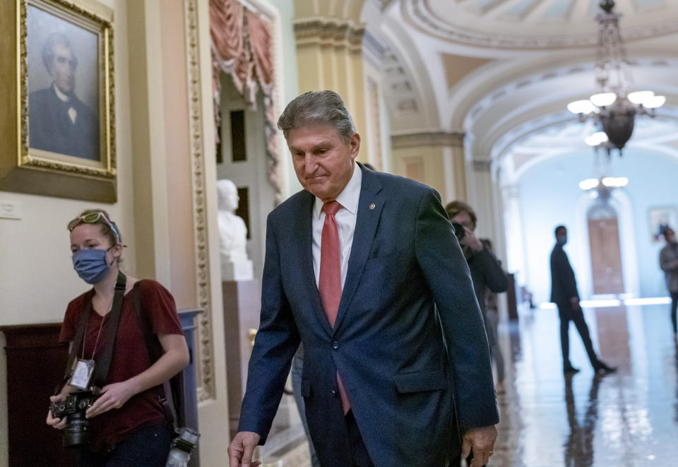 FILE - Sen. Joe Manchin, D-W.Va., walks to a caucus lunch at the Capitol in Washington, Dec. 17, 2021. Manchin said Sunday, Dec. 19, 2021 he cannot back a $2 trillion social safety net bill, dealing a potentially fatal blow to President Joe Biden’s signature legislation. (AP Photo/J. Scott Applewhite, file)