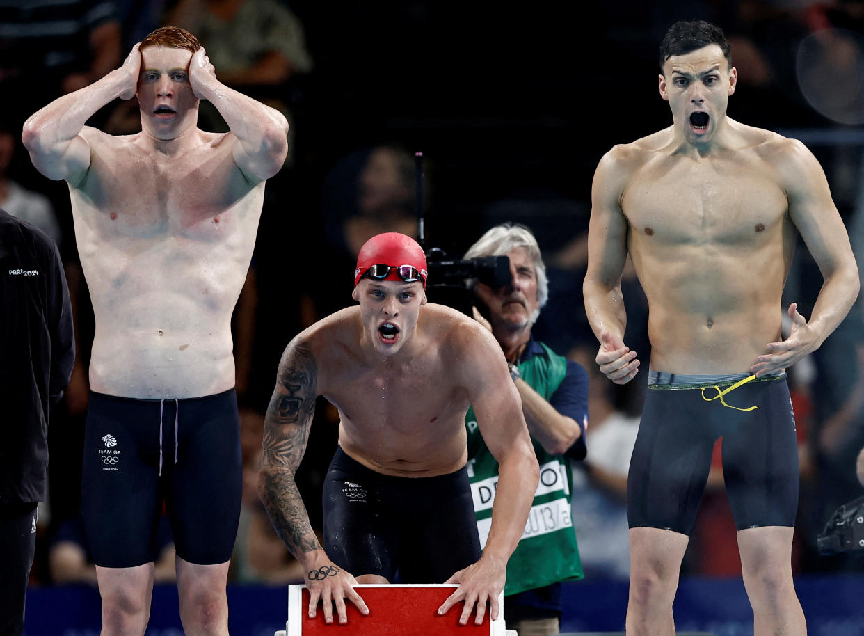 James Guy of Britain, Tom Dean of Britain and Matthew Richards of Britain react during the Men's 4 x 200m Freestyle Relay Final on July 30, 2024. (Clodagh Kilcoyne/Reuters)