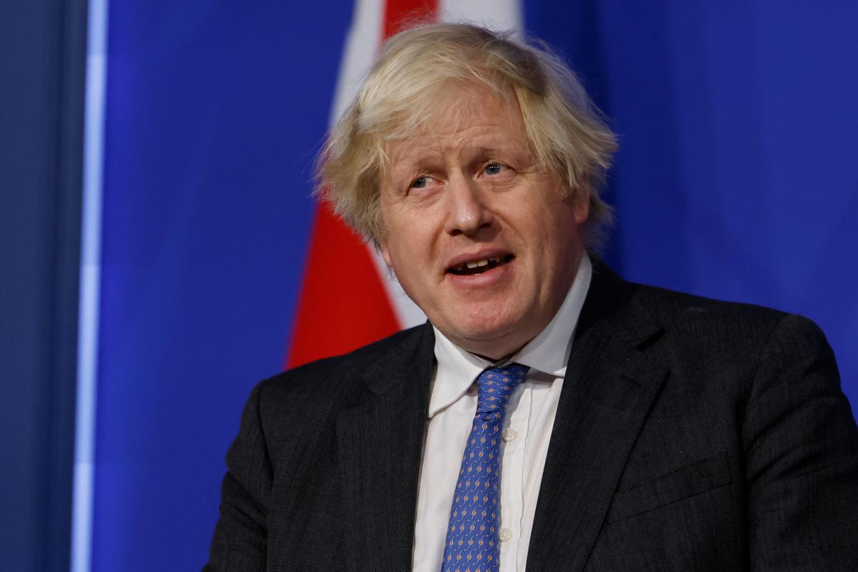 Britain's Prime Minister Boris Johnson speaks at a press conference to update the nation on the Covid-19 booster vaccine program in the Downing Street briefing room in central London on December 15, 2021. - British Prime Minister Boris Johnson on Wednesday defended his record on tackling the coronavirus pandemic, after nearly 100 of his own MPs broke ranks and rebelled against new restrictions. (Photo by Tolga Akmen / POOL / AFP) (Photo by TOLGA AKMEN/POOL/AFP via Getty Images)