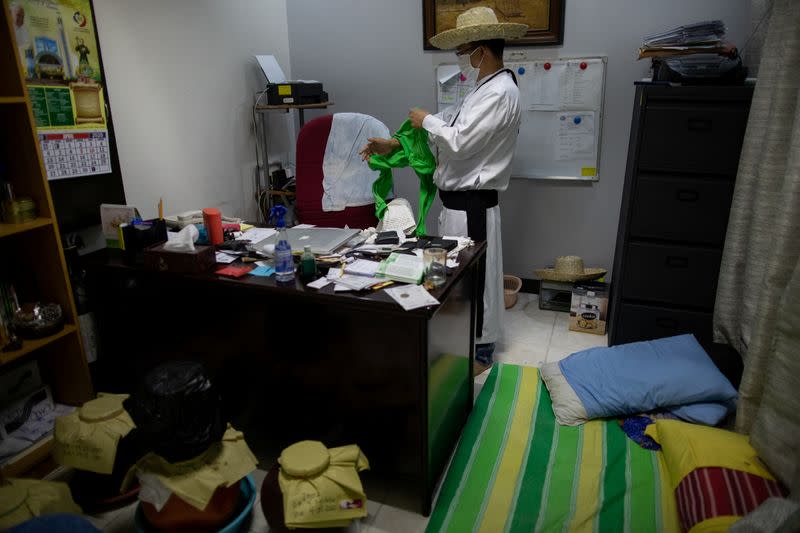 The Wider Image: Hazmat suits and holy water: two priests bring faith to Philippines lockdown