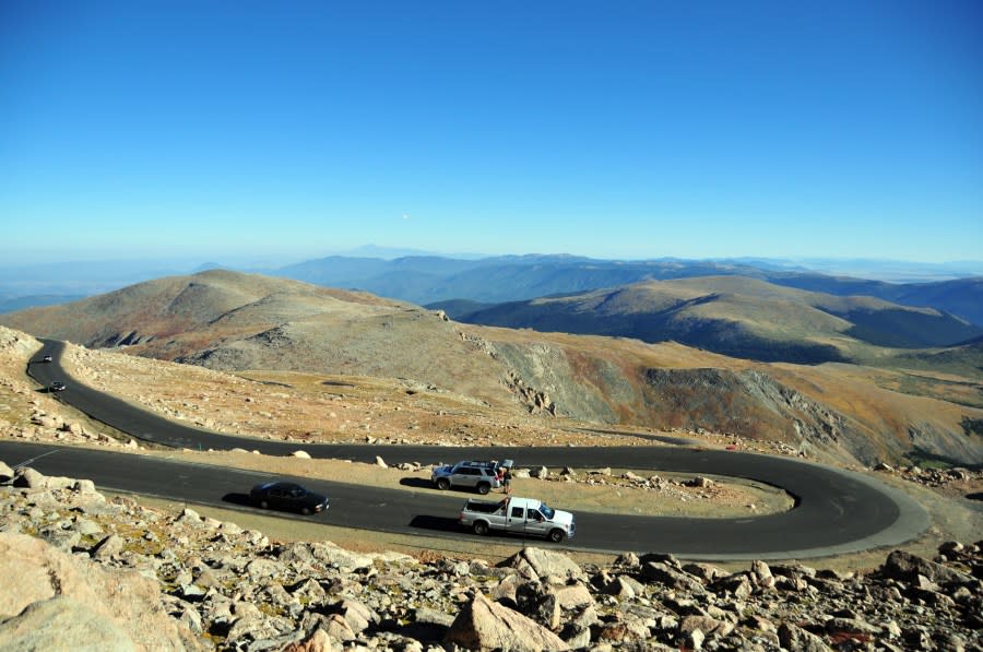 Cars go down a switchback curve on Mount Blue Sky Scenic Byway