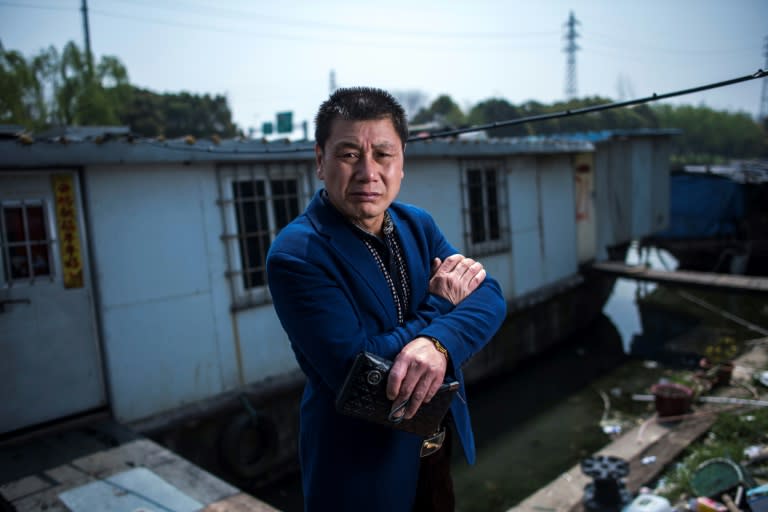 Garbage collector Li Chaoqing faces eviction along with about 200 other squatters living in decaying vessels on the Xinchapu River as officials push a river clean-up campaign