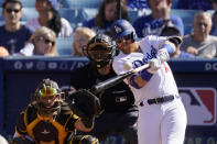 Los Angeles Dodgers' Justin Turner, right, hits a solo home run as San Diego Padres catcher Austin Nola, left, and home plate umpire Ben May watch during the first inning of a baseball game Saturday, July 2, 2022, in Los Angeles. (AP Photo/Mark J. Terrill)