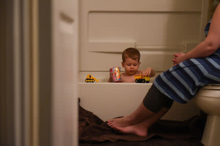 Lauren Hoffmann bathes her son Asa on her last day of maternity leave in San Antonio, Texas, U.S., February 12, 2019. REUTERS/Callaghan O'Hare