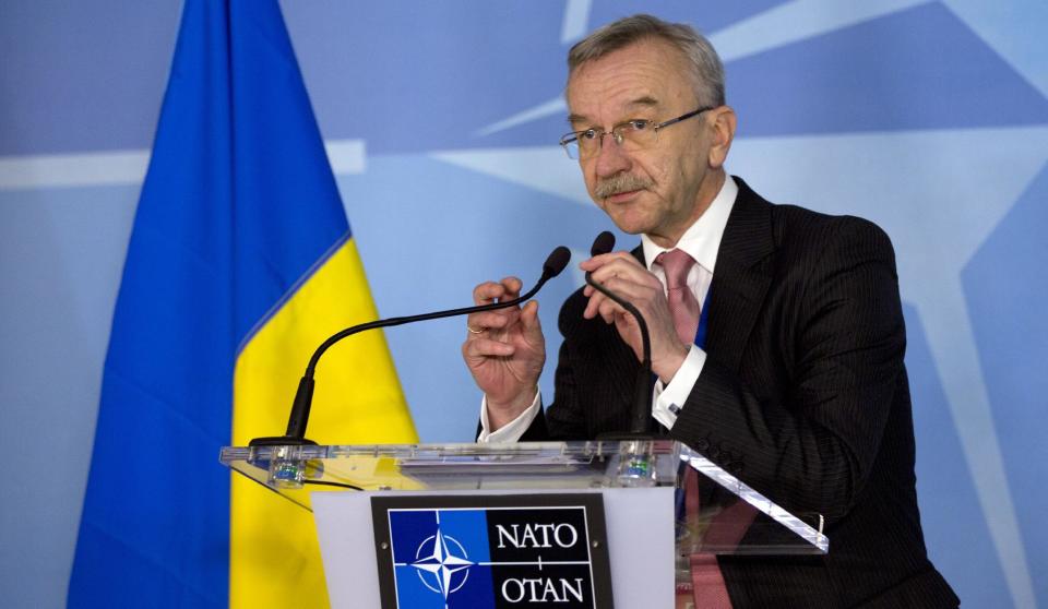 Ukraine's Ambassador to NATO Ihor Dolhov adjusts the microphones prior to speaking during a media conference at NATO headquarters in Brussels on Sunday, March 2, 2014. NATO is called emergency talks on Sunday regarding the escalating crisis in Ukraine. (AP Photo/Virginia Mayo)