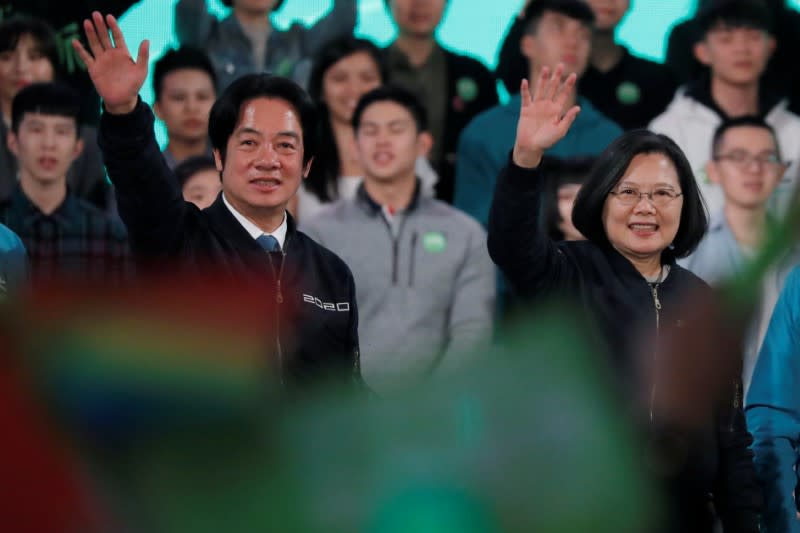 Taiwan President Tsai Ing-wen and the Democratic Progressive Party's (DPP) vice presidential candidate William Lai wave to their supporters during a final campaign rally ahead of the elections in Taipei