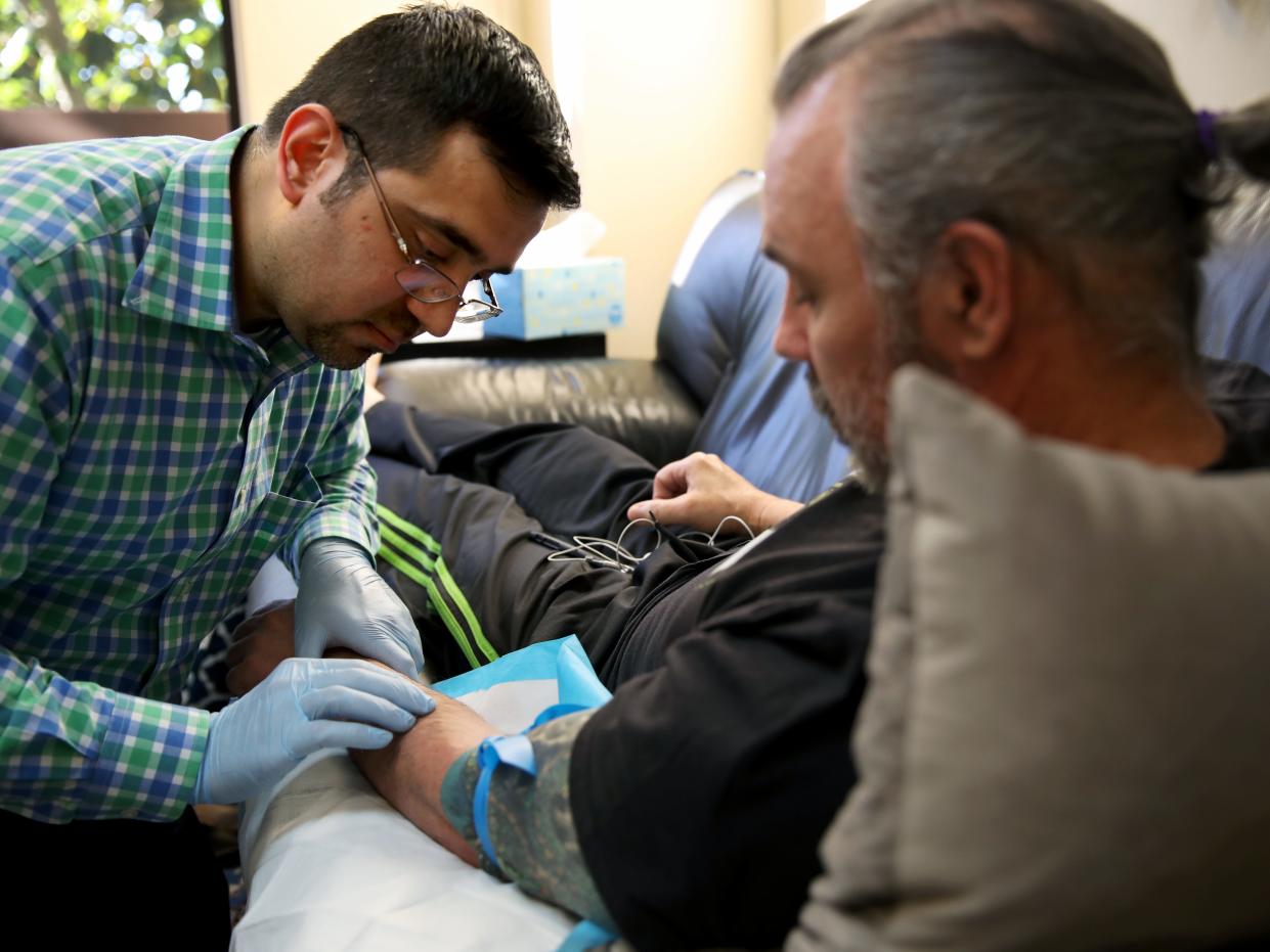 A doctor prepares to give intravenous ketamine at a clinic in California in 2019.