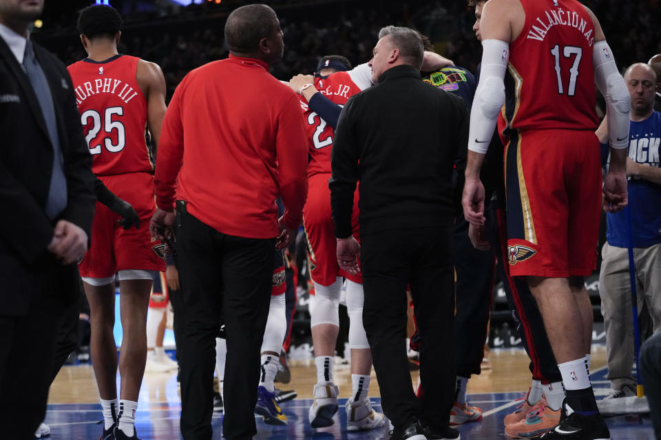 New Orleans Pelicans forward Larry Nance Jr., center is helped off the court during the first half of the team's NBA basketball game against the New York Knicks, Saturday, Feb. 25, 2023, at Madison Square Garden in New York. (AP Photo/Mary Altaffer)