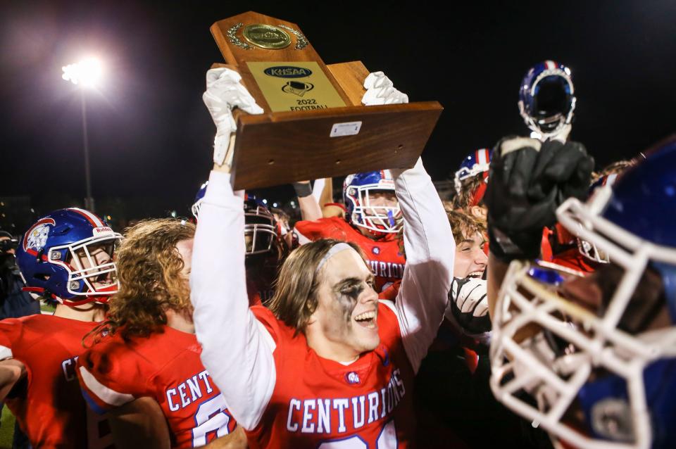 CAL senior Philip Russell holds up the 3A KHSAA football semifinal winning trophy after the Centurions defeated Ashland Friday night in Louisville. The Centurions easily won 50-7 to advance to the state championship game. Nov. 25, 2022.