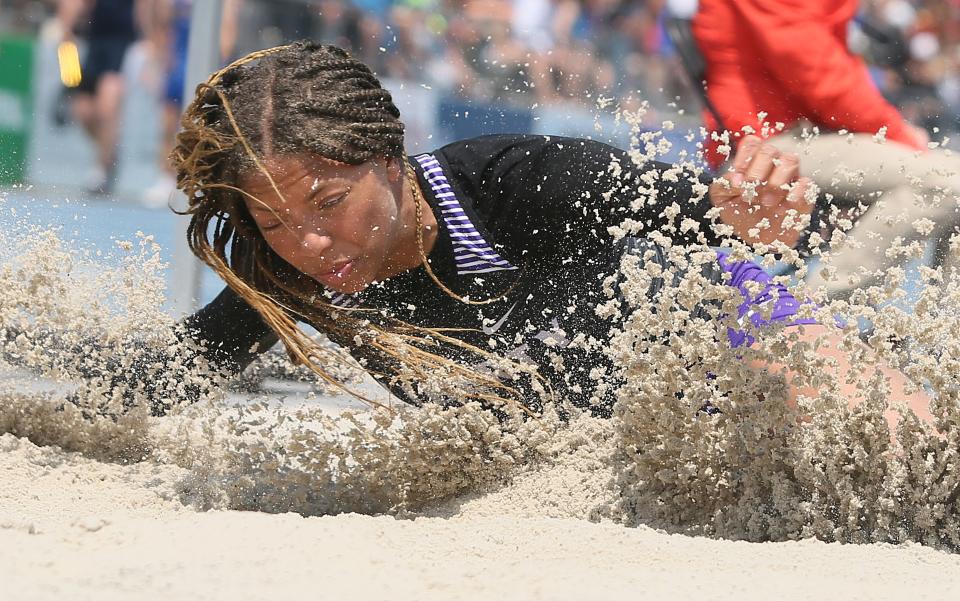 Iowa City Liberty's Alexi Thigpen lands during the 4A girls long jump at the state track meet. Thigpen finished the event in third place.