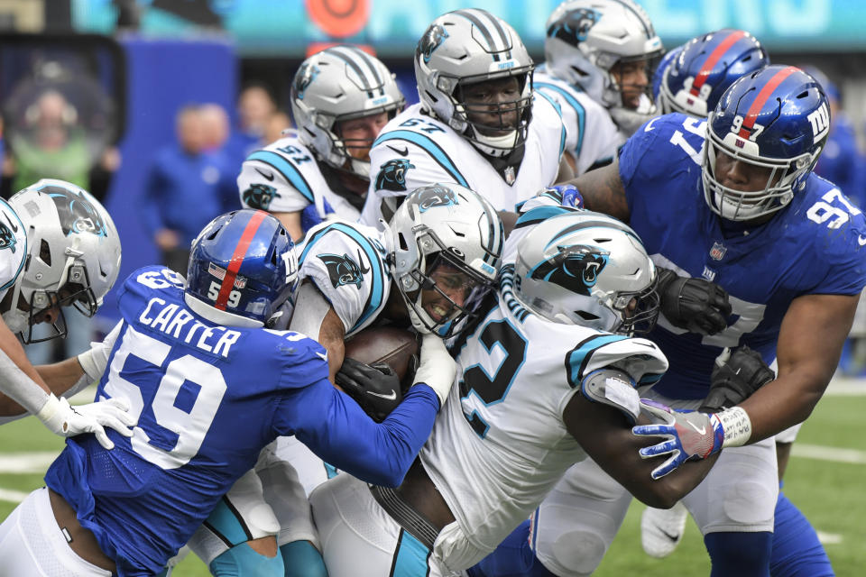 New York Giants' Lorenzo Carter (59) tackles Carolina Panthers running back Chuba Hubbard (30) during the first half of an NFL football game, Sunday, Oct. 24, 2021, in East Rutherford, N.J. (AP Photo/Bill Kostroun)