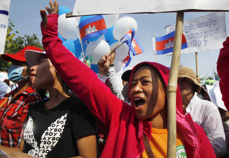 FILE - In this May 1, 2015, file photo, garment workers shout slogans during a gathering to mark May Day celebrations in Phnom Penh, Cambodia. Cambodia's government announced Friday it is raising the minimum wage for the garment industry, the country's biggest export earner, whose workers make up a powerful political bloc. (AP Photo/Heng Sinith, File)